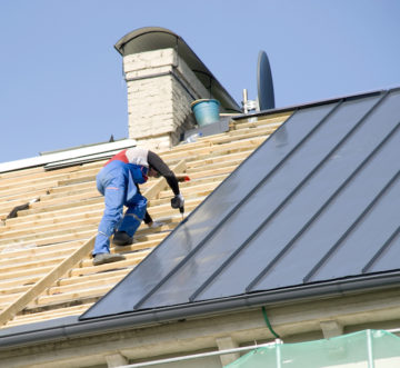 man building energy efficient metal roof home